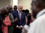 President Joe Biden, fourth left, bows his head as Reverend Dr. Jamey O. Graham Sr., in foreground at right, speaks at St. John Baptist Church, in Columbia, S.C., on Sunday, Jan. 28, 2024. To the left of Biden is Rep. Jim Clyburn, D-S.C. (AP Photo/Jacquelyn Martin)