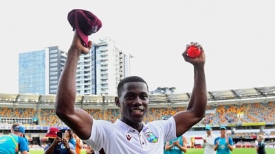 West Indies' Shamar Joseph raises the ball after taking 7 wickets. (AP) West Indies' Shamar Joseph raises the ball after taking 7 wickets. (AP)