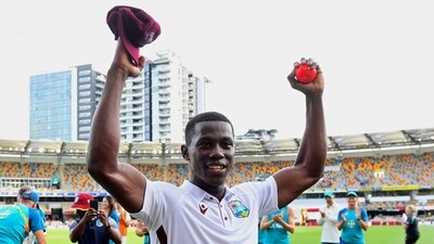 West Indies' Shamar Joseph raises the ball after taking 7 wickets in his team's win over Australia on the 4th day of 2nd Test (AP)