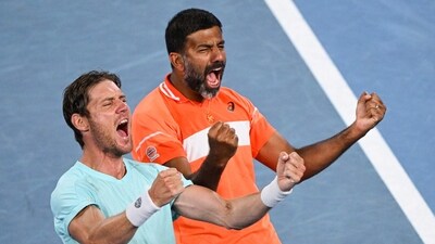 Rohan Bopanna (R) and Australia's Matthew Ebden celebrate after victory against Italy's Simone Bolelli and Andrea Vavassori during their men's doubles final match on day 14 of the Australian Open tennis tournament in Melbourne on January 27, 2024 (AFP)