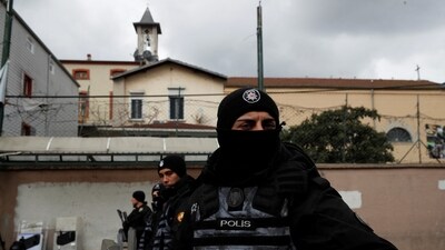 Turkish police stand guard outside the Italian Santa Maria Catholic Church after two masked gunmen shot one person dead during Sunday service, in Istanbul, Turkey (REUTERS)