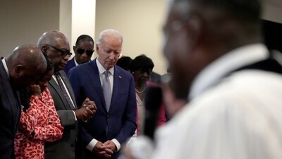 President Joe Biden, fourth left, bows his head as Reverend Dr. Jamey O. Graham Sr., in foreground at right, speaks at St. John Baptist Church, in Columbia, S.C., on Sunday, Jan. 28, 2024. To the left of Biden is Rep. Jim Clyburn, D-S.C. (AP Photo/Jacquelyn Martin) (AP) President Joe Biden, fourth left, bows his head as Reverend Dr. Jamey O. Graham Sr., in foreground at right, speaks at St. John Baptist Church, in Columbia, S.C., on Sunday, Jan. 28, 2024. To the left of Biden is Rep. Jim Clyburn, D-S.C. (AP Photo/Jacquelyn Martin) (AP)
