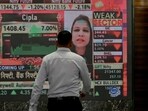 A man walks past a digital display inside the Bombay Stock Exchange (BSE) building in Mumbai. A man walks past a digital display inside the Bombay Stock Exchange (BSE) building in Mumbai.