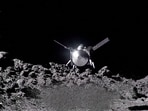 The NASA spacecraft OSIRIS-APEX hovers over the surface of the near-Earth asteroid Apophis, using its thrusters to disturb the asteroid's surface to reveal what lies beneath. NASA's Goddard Space Flight Center/Handout via REUTERS  