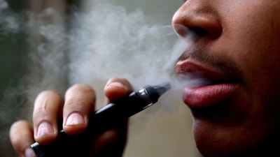 A man smokes a disposable vape, Newcastle-under-Lyme, Britain. (REUTERS)