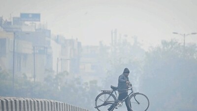 Commuters seen out on a cold and foggy day at JLN Stadium in New Delhi, India. (Hindustan Times) Commuters seen out on a cold and foggy day at JLN Stadium in New Delhi, India. (Hindustan Times)
