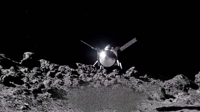 The NASA spacecraft OSIRIS-APEX hovers over the surface of the near-Earth asteroid Apophis, using its thrusters to disturb the asteroid's surface to reveal what lies beneath. NASA's Goddard Space Flight Center/Handout via REUTERS (via REUTERS)