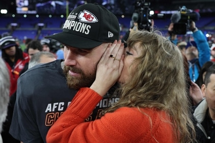 BALTIMORE, MARYLAND - JANUARY 28: Travis Kelce #87 of the Kansas City Chiefs celebrates with Taylor Swift as she whispers in his ear after a 17-10 victory against the Baltimore Ravens in the AFC Championship Game at M&T Bank Stadium on January 28, 2024 in Baltimore, Maryland. (Getty Images via AFP)