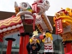 A man lifts a child on his shoulders near Chinese New Year themed decoration ahead of the upcoming Chinese Lunar New Year in Beijing, China on Saturday, Jan. 20, 2024. (AP Photo/Ng Han Guan) A man lifts a child on his shoulders near Chinese New Year themed decoration ahead of the upcoming Chinese Lunar New Year in Beijing, China on Saturday, Jan. 20, 2024. (AP Photo/Ng Han Guan)