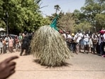 A performer wearing the traditional kumbo mask, a mythological figure of the jola tribe dressed with palm leaves, dances during the kankurang Festival in Janjanbureh on January 27, 2024. A performer wearing the traditional kumbo mask, a mythological figure of the jola tribe dressed with palm leaves, dances during the kankurang Festival in Janjanbureh on January 27, 2024.
