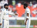 India's captain Rohit Sharma, left, speaks with Jasprit Bumrah