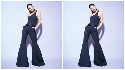 Kriti's jumpsuit comes in a stunning midnight blue shade and features a one-shoulder neckline, a bodycon fit that perfectly accentuates her gorgeous curves and a retro-chic bell-bottom style trouser that exudes the vintage chic vibe. (Instagram/@kritisanon) Kriti's jumpsuit comes in a stunning midnight blue shade and features a one-shoulder neckline, a bodycon fit that perfectly accentuates her gorgeous curves and a retro-chic bell-bottom style trouser that exudes the vintage chic vibe. (Instagram/@kritisanon)