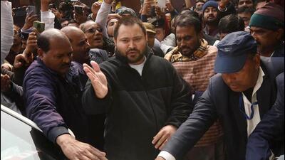 After coming out of the ED office, Tejashwi flashed a victory symbol and drove away. (Photo by Santosh Kumar/ Hindustan Times)