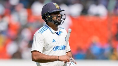 India's captain Rohit Sharma reacts as he leaves the field after losing his wicket to England's Tom Hartley (AP)