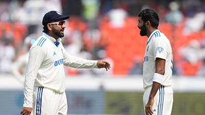 India's captain Rohit Sharma, left, speaks with Jasprit Bumrah (AP)
