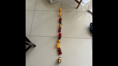 The picture shows toy cars lined up by the toddler on the floor. (X/@pavanbhatk) The picture shows toy cars lined up by the toddler on the floor. (X/@pavanbhatk)