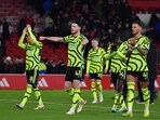 Arsenal's players wave their supporters at the end of the English Premier League soccer match between Nottingham Forest and Arsenal at the City Ground stadium in Nottingham, England