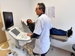Tunisian doctor and professor of gynecology Fethi Zhiwa specializing in infertility, examines Bintou Yunoussa, 25, at a clinic in Tunis. While Tunisians face economic hardships and their government is mired in debt, medical tourism has thrived, seeing more than two million foreigners travel to Tunisia annually for medical procedures, a profitable sector the authorities are looking to expand even further. 