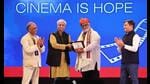Director of the Pune International Film Festival, Jabbar Patel, presenting the SD Burman International Award to music director MM Keeravani. (Courtesy the Pune International Film Festival on X @piffindia)
