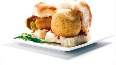 Mumbai: Mumbai, known for its vibrant food scene, offers a diverse array of culinary delights that cater to every palate. Among its famous foods are Vada Pav, often hailed as the city's iconic street food, featuring a spicy potato fritter nestled in a pav with chutneys. Pav Bhaji is another favorite, consisting of a spicy vegetable mash served with buttered pav. (File Photo) Mumbai: Mumbai, known for its vibrant food scene, offers a diverse array of culinary delights that cater to every palate. Among its famous foods are Vada Pav, often hailed as the city's iconic street food, featuring a spicy potato fritter nestled in a pav with chutneys. Pav Bhaji is another favorite, consisting of a spicy vegetable mash served with buttered pav. (File Photo)