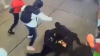 A horrifying video has captured the moment a migrant mob attacked a pair of police officers and brutally thrashed them near Times Square (NYPD Crime Stoppers/X) A horrifying video has captured the moment a migrant mob attacked a pair of police officers and brutally thrashed them near Times Square (NYPD Crime Stoppers/X)