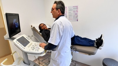 Tunisian doctor and professor of gynecology Fethi Zhiwa specializing in infertility, examines Bintou Yunoussa, 25, at a clinic in Tunis. While Tunisians face economic hardships and their government is mired in debt, medical tourism has thrived, seeing more than two million foreigners travel to Tunisia annually for medical procedures, a profitable sector the authorities are looking to expand even further. (Photo by FETHI BELAID / AFP) Tunisian doctor and professor of gynecology Fethi Zhiwa specializing in infertility, examines Bintou Yunoussa, 25, at a clinic in Tunis. While Tunisians face economic hardships and their government is mired in debt, medical tourism has thrived, seeing more than two million foreigners travel to Tunisia annually for medical procedures, a profitable sector the authorities are looking to expand even further. (Photo by FETHI BELAID / AFP)