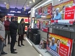 People watch the live telecast of the interim budget 2024 by Union finance minister Nirmala Sitharaman, at a showroom in Gurugram, on Thursday. 