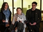 Climate activist Greta Thunberg gives a statement next to activist Chris Kebbon and Joshua James Unwin outside Westminster Magistrates' Court 