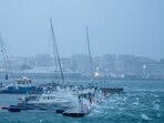 Boats sway in the harbour as waves batter a dock during Storm Ingunn in Bodo, Norway 