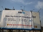 Workers adjust a hoarding of Paytm, a digital payments firm, in Ahmedabad.