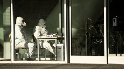 Covid In China: Security guards wearing personal protective equipment (PPE) amid the Covid-19 pandemic sit at an entrance of a building in Beijing. (AFP) Covid In China: Security guards wearing personal protective equipment (PPE) amid the Covid-19 pandemic sit at an entrance of a building in Beijing. (AFP)