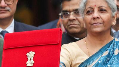 Finance minister Nirmala Sitharaman holds up a folder as she leaves her office to present the interim budget. (REUTERS) Finance minister Nirmala Sitharaman holds up a folder as she leaves her office to present the interim budget. (REUTERS)
