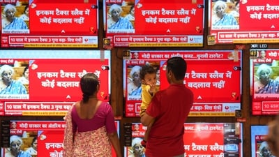 People at a TV showroom during presentation of the Interim Budget 2024 in the Parliament by union finance minister Nirmala Sitharaman in Mumbai on Thursday. (PTI) People at a TV showroom during presentation of the Interim Budget 2024 in the Parliament by union finance minister Nirmala Sitharaman in Mumbai on Thursday. (PTI)