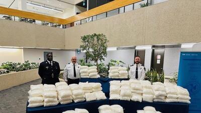 Police officers with drugs allegedly seized during the arrest of Indo-Canadian trucker Komalpreet Sidhu. (Manitoba RCMP) Police officers with drugs allegedly seized during the arrest of Indo-Canadian trucker Komalpreet Sidhu. (Manitoba RCMP)