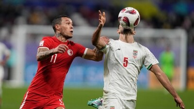 Hong Kong's Everton Camargo, left, and Iran's Milas Mohammadikeshmarzi vie for the ball during the Asian Cup Group C soccer match between Hong Kong and Iran at Khalifa International Stadium in Doha, Qatar (AP) Hong Kong's Everton Camargo, left, and Iran's Milas Mohammadikeshmarzi vie for the ball during the Asian Cup Group C soccer match between Hong Kong and Iran at Khalifa International Stadium in Doha, Qatar (AP)
