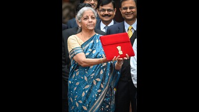 Union Minister of Finance Nirmala Sitharaman, along with Bhagwat Karad and Pankaj Chaudhary MOS Finance, leaves the Finance Ministry carrying the Finance Budget ahead of the presentation of interim Budget 2024 in Parliament at North Block in New Delhi. (Hindustan Times) Union Minister of Finance Nirmala Sitharaman, along with Bhagwat Karad and Pankaj Chaudhary MOS Finance, leaves the Finance Ministry carrying the Finance Budget ahead of the presentation of interim Budget 2024 in Parliament at North Block in New Delhi. (Hindustan Times)