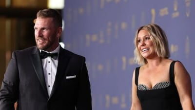 Australia's T20 World Cup-winning former captain Aaron Finch arrives with wife Amy Finch (CA) Australia's T20 World Cup-winning former captain Aaron Finch arrives with wife Amy Finch (CA)