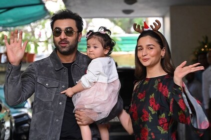 Bollywood actors Ranbir Kapoor and Alia Bhatt pose with their daughter Raha upon their arrival for a Christmas brunch in Mumbai on December 25, 2023. (File Photo/AFP)