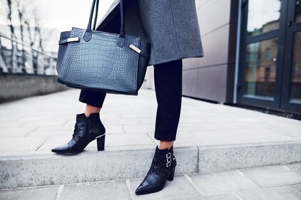 Match grey or black boots with black pants and a coat for some neat workplace style (Shutterstock)