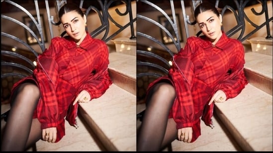 Kriti's outfit features a collar neckline, full sleeves, a front button closure, a belt at the waist, buttoned cuffs and a medium-weight poplin fabric. The chic red checked print that adorns her dress all over elevates her entire outfit and adds a trendy vibe to her look.(Instagram/@sukritigrover)