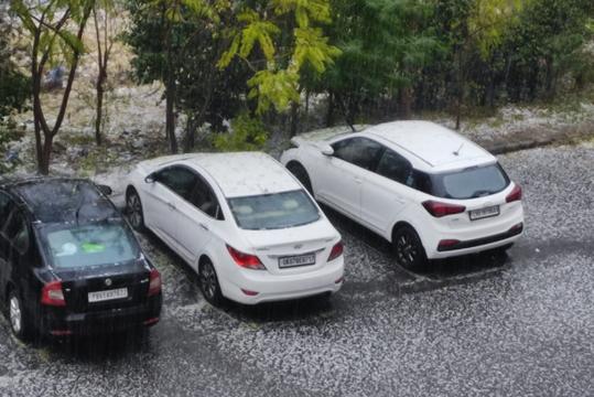 Cars parked on a road covered with hail in Chandigarh on Thursday. (Sanjeev Kumar/HT) Cars parked on a road covered with hail in Chandigarh on Thursday. (Sanjeev Kumar/HT)