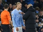 Manchester City's Pep Guardiola (R) speaks to Erling Haaland. Manchester City's Pep Guardiola (R) speaks to Erling Haaland.