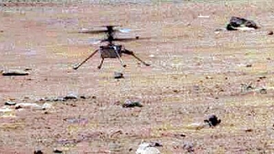 This NASA photo obtained May 23, 2021 shows NASA's Ingenuity Mars Helicopter as it lands with a soft bounce (AFP) This NASA photo obtained May 23, 2021 shows NASA's Ingenuity Mars Helicopter as it lands with a soft bounce (AFP)