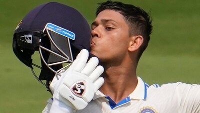 Yashasvi Jaiswal kisses his helmet after scoring a century on the first day of the second Test. (AP)