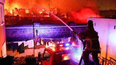 TOPSHOT - Firemen extinguish a blaze following a series of explosions in the Embakasi area of Nairobi on February 2, 2024. At least 30 people have been transferred to different hospitals, according to the Kenya Red Cross, after explosions rocked an industrial and residential area of the Kenyan capital. (Photo by SIMON MAINA / AFP) (AFP)