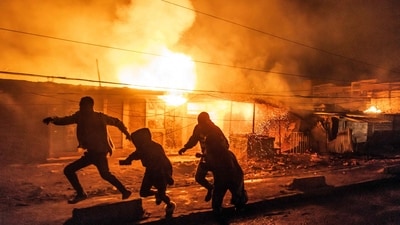 People run for cover following a series of explosions in the Embakasi area of Nairobi on February 2, 2024. (AFP)