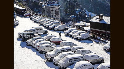Parked cars covered with snow in Shimla on Friday (HT Photo)