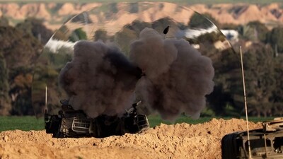 A shock wave is visible as an Israeli army self-propelled artillery fires a round from southern Israel toward the Gaza Strip (AFP) A shock wave is visible as an Israeli army self-propelled artillery fires a round from southern Israel toward the Gaza Strip (AFP)