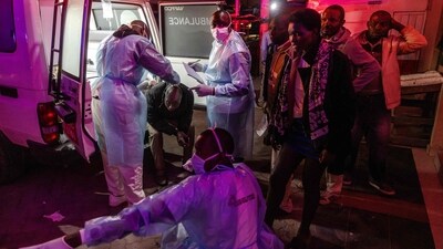 Medical responders tend to an injured man as others queue for aid next to an ambulance following a series of explosions in the Embakasi area of Nairobi, Kenya. (AFP) Medical responders tend to an injured man as others queue for aid next to an ambulance following a series of explosions in the Embakasi area of Nairobi, Kenya. (AFP)