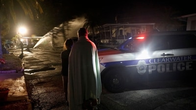 Residents at the Bayside Waters watch EMS personnel respond after a small plane crashed into the mobile home park in Clearwater, Florida, on February 1, 2024. There are "several fatalities both from the aircraft and within the mobile home,� Fire Chief Scott Ehlers said. (Photo by OCTAVIO JONES / AFP) (AFP) Residents at the Bayside Waters watch EMS personnel respond after a small plane crashed into the mobile home park in Clearwater, Florida, on February 1, 2024. There are "several fatalities both from the aircraft and within the mobile home,� Fire Chief Scott Ehlers said. (Photo by OCTAVIO JONES / AFP) (AFP)